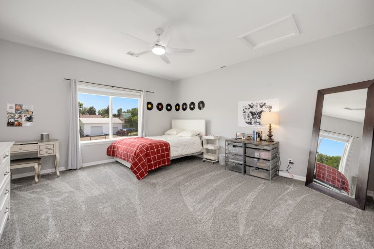 Cream wall-to-wall carpet in a bright Arkansas bedroom