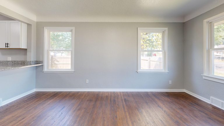 Freshly refinished hardwood flooring in an empty sunlit Arkansas room