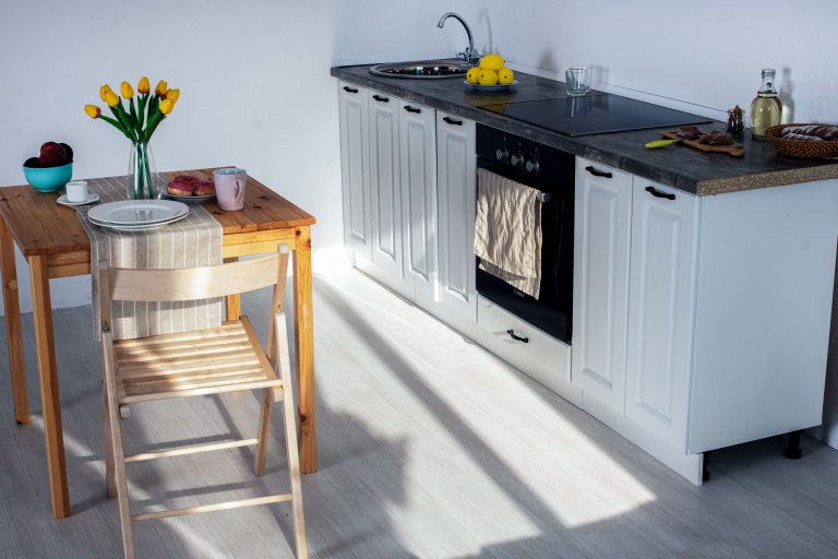 Wood-look flooring in a bright Arkansas kitchen with pale cabinets
